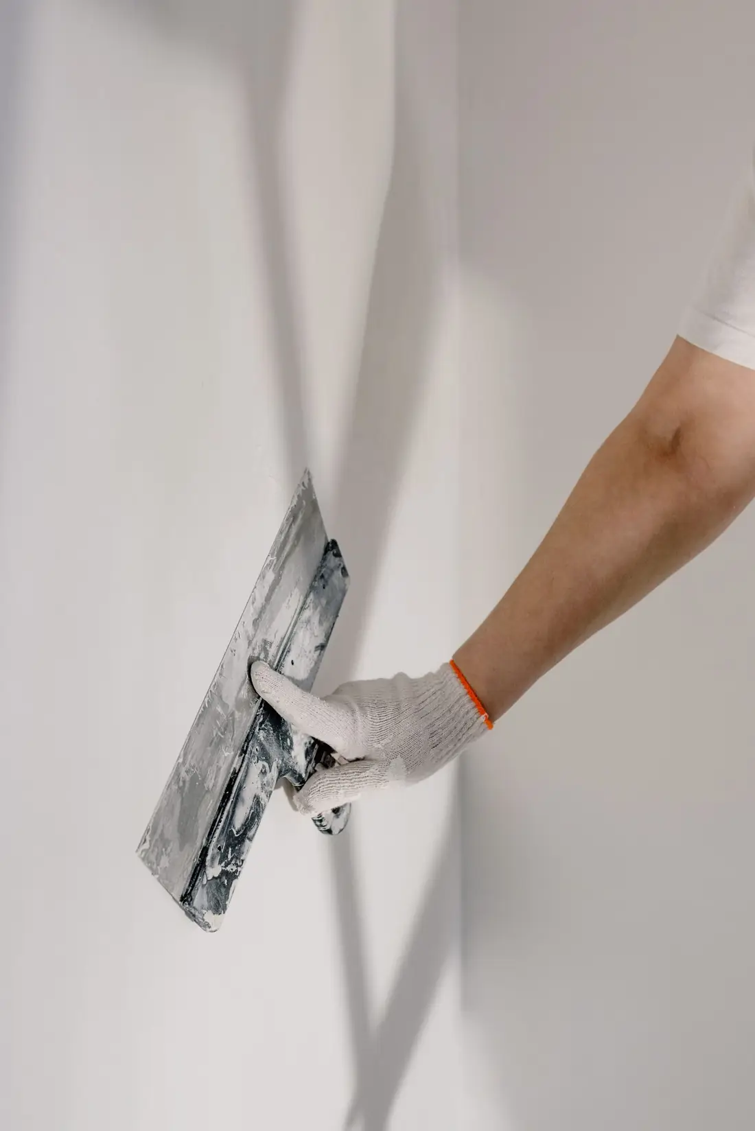 Illustrative photo of a person preparing a wall. Not ATR Decorators staff.